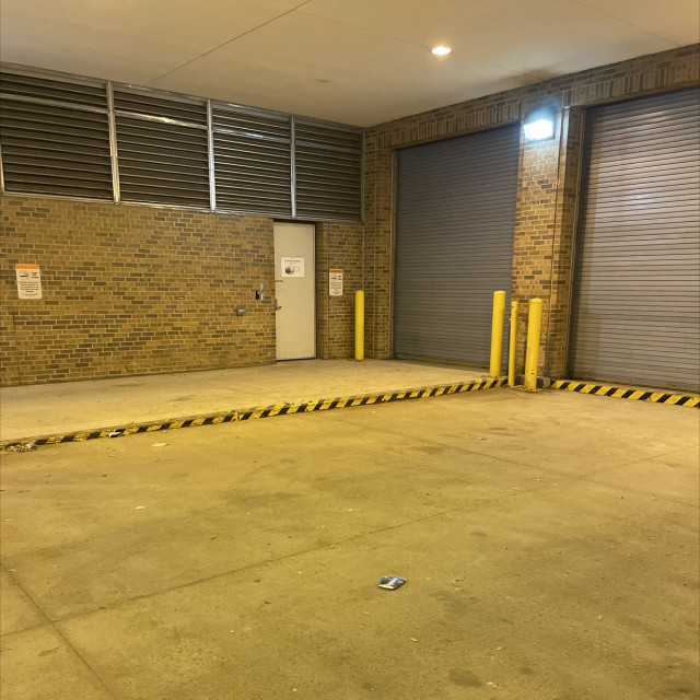 Metal covered curb in a covered and lighted loading dock area